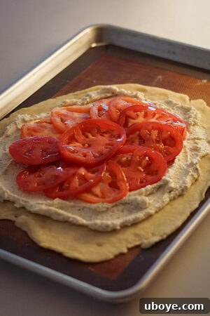 Spreading vegan feta filling on the galette dough
