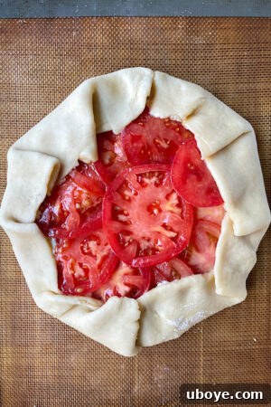 Folding the edges of the galette dough over the filling