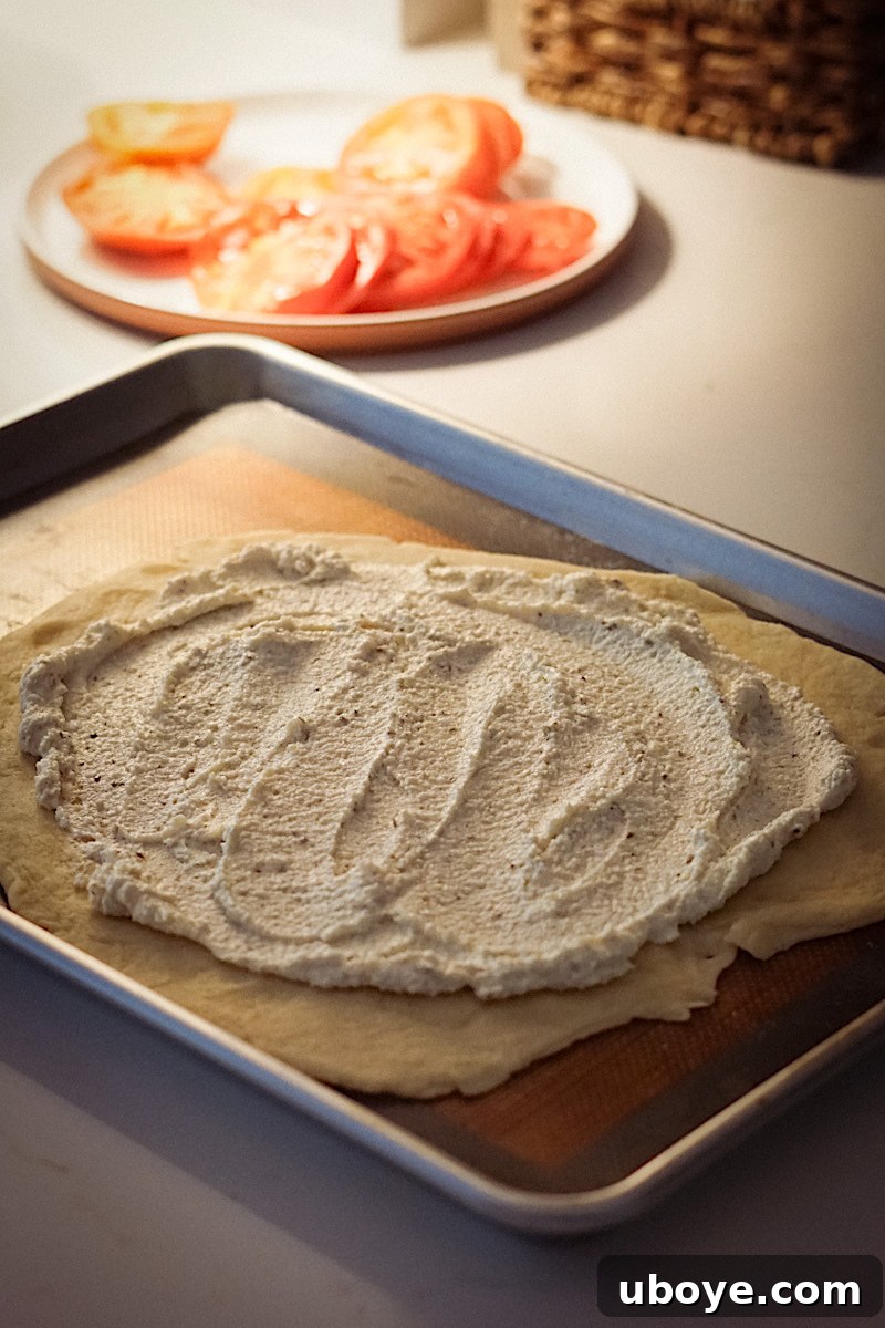 Spreading vegan feta filling on the galette dough