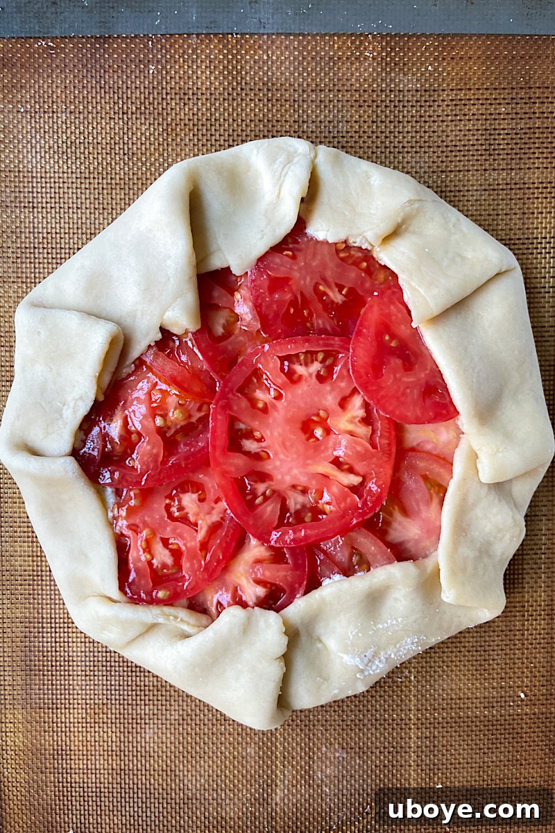 Folding the edges of the galette dough over the filling