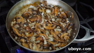 Savory Balsamic Mushroom Tortellini 10 Mushrooms and onions cooking in a skillet with olive oil.