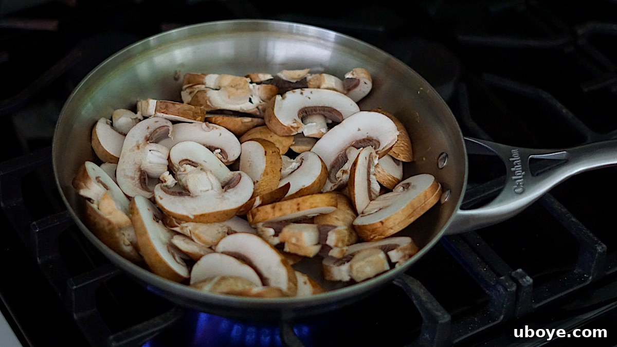 Savory Balsamic Mushroom Tortellini 5 Mushrooms browning in a hot stainless steel skillet.