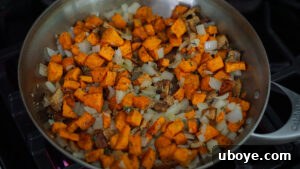 Savory Sweet Potato Skillet 12 Sautéed vegetables and vegan bacon in a pan