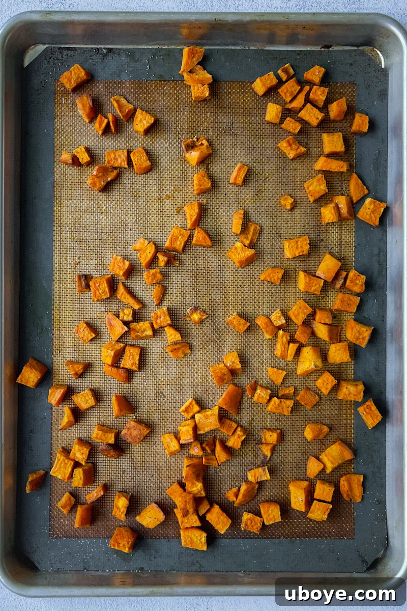 Savory Sweet Potato Skillet 5 Roasted sweet potatoes on a baking sheet, golden brown and tender