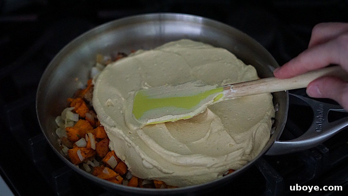 Savory Sweet Potato Skillet 7 Tofu mixture and vegetables combined in a frying pan, smoothed out, before cooking