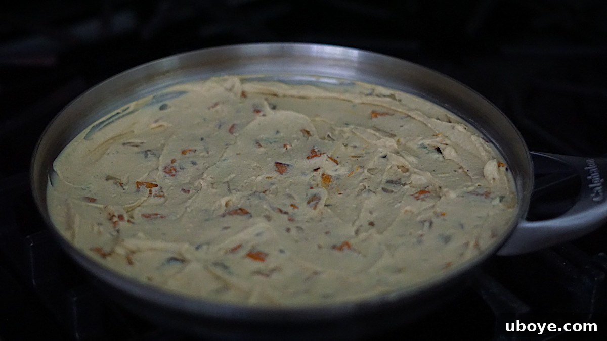 Savory Sweet Potato Skillet 8 Vegan cheddar cheese generously sprinkled on top of the frittata mixture in a pan