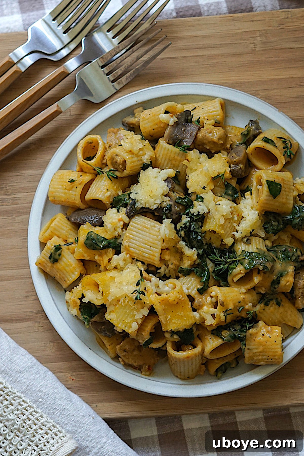 Golden Pumpkin Pasta Casserole 3 Close-up of the creamy pumpkin pasta bake with visible rigatoni, vegan sausage, and kale, showing its rich texture.