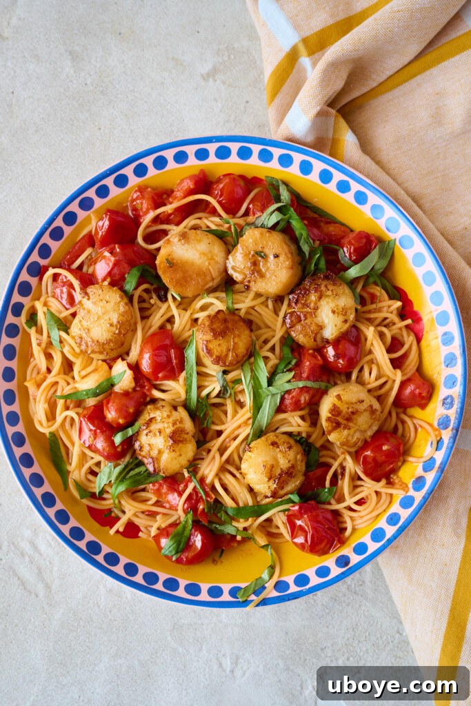Brown Butter Scallop Pasta with Blistered Cherry Tomatoes 7 Cooked pasta being tossed with the cherry tomato sauce in a pan.