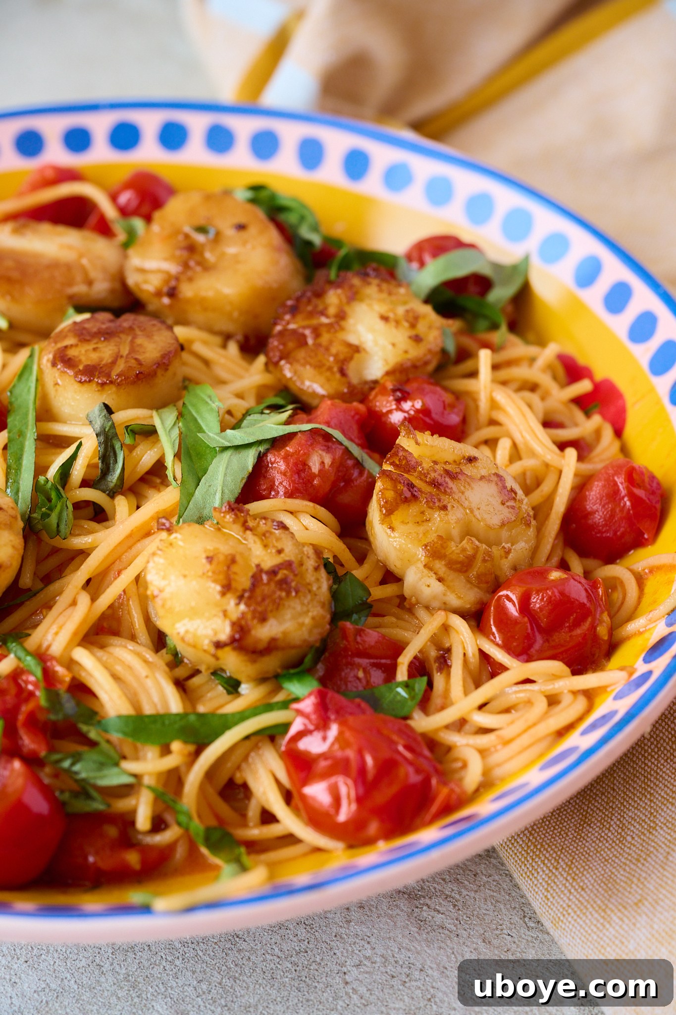 Brown Butter Scallop Pasta with Blistered Cherry Tomatoes 8 A vibrant bowl of scallop pasta with cherry tomatoes and fresh basil, ready to be enjoyed.