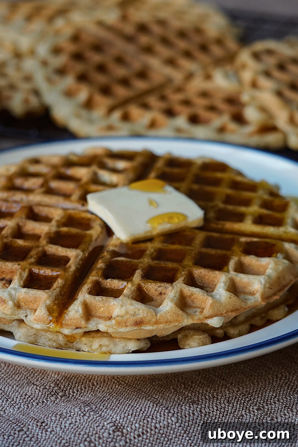 Effortless Plant-Based Waffle Perfection 3 Close-up of a stack of fluffy vegan waffles drizzled with maple syrup