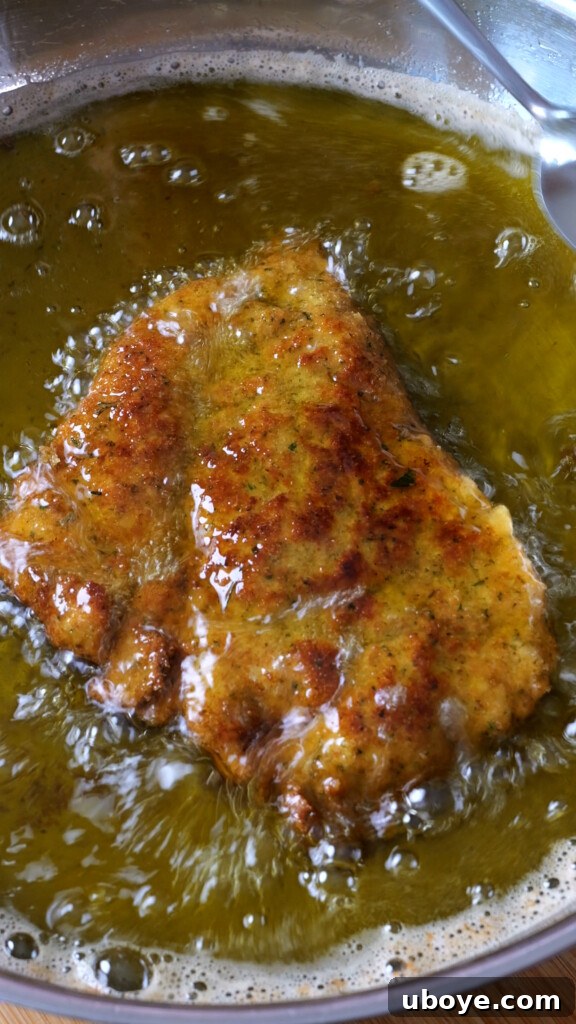 Zesty Lemon Chicken Orzo 9 Orzo pasta being toasted in the pan with fragrant aromatics, absorbing the buttery goodness.