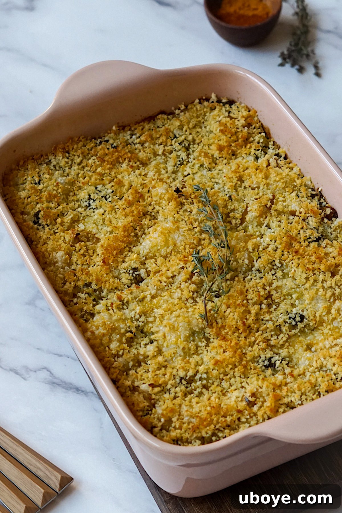 Hearty Plant-Based Broccoli Cheddar Bake 2 Delicious Plant-Based Broccoli Cheddar Casserole, garnished with fresh herbs