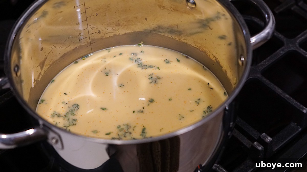 Hearty Plant-Based Broccoli Cheddar Bake 6 Pouring creamy sauce over the casserole ingredients