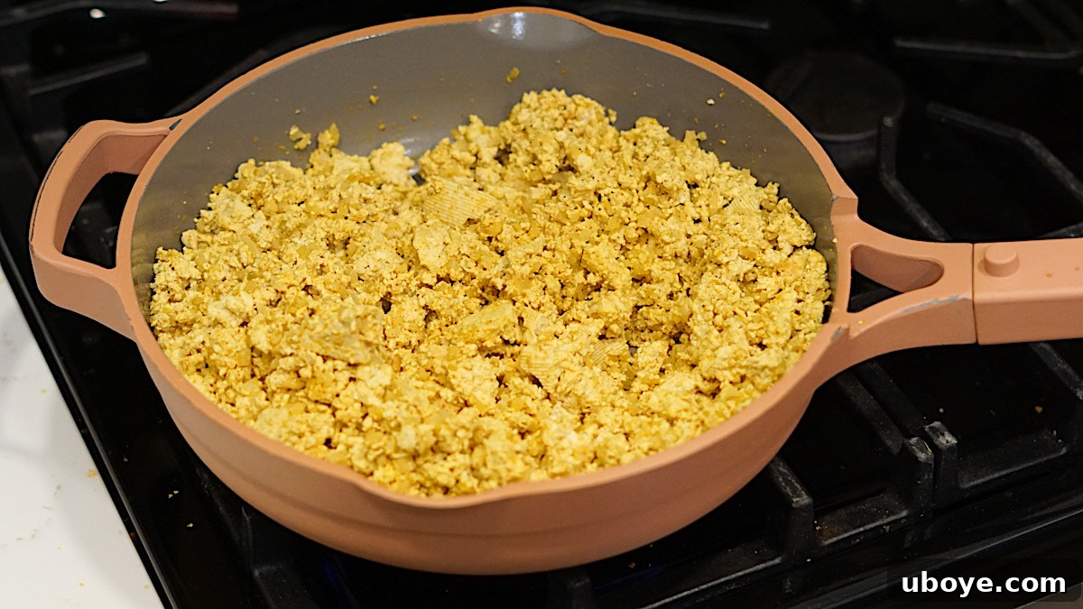 Prepared tofu scramble in a large skillet, ready for burrito assembly