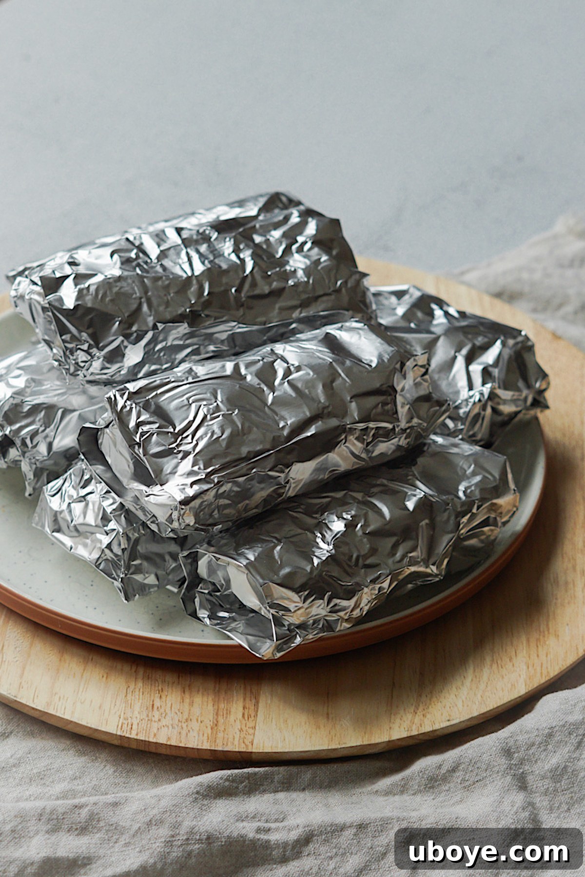 Homemade burritos wrapped in foil, ready for freezer storage