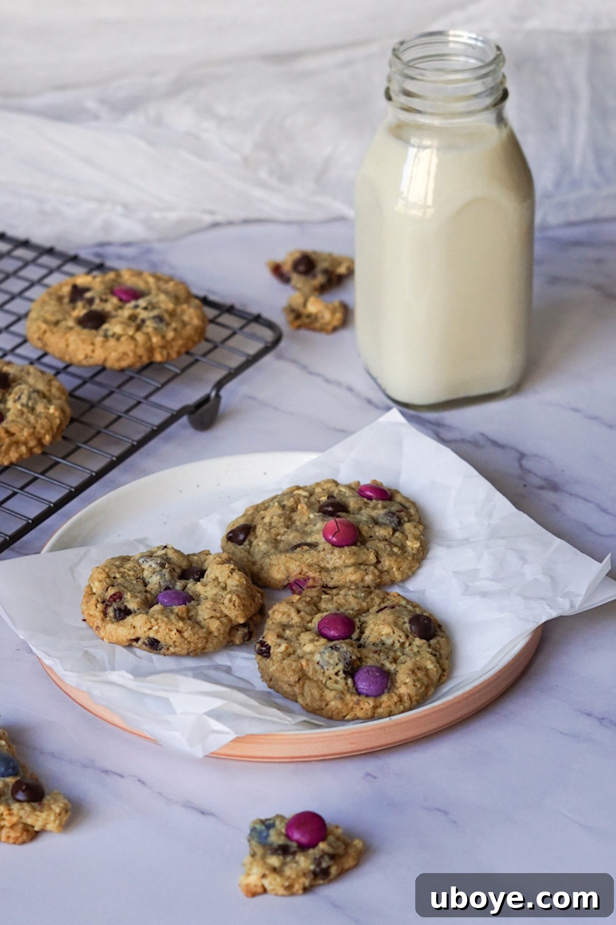 Ultimate Vegan Mix-In Cookies 7 Freshly baked vegan kitchen sink cookies cooling on a baking sheet, with a beautiful golden color and visible add-ins.