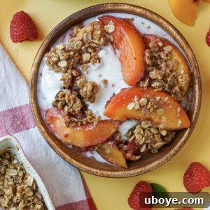 Golden Peach Raspberry Bake 6 peach and raspberry crumble on a bamboo plate with melted ice cream
