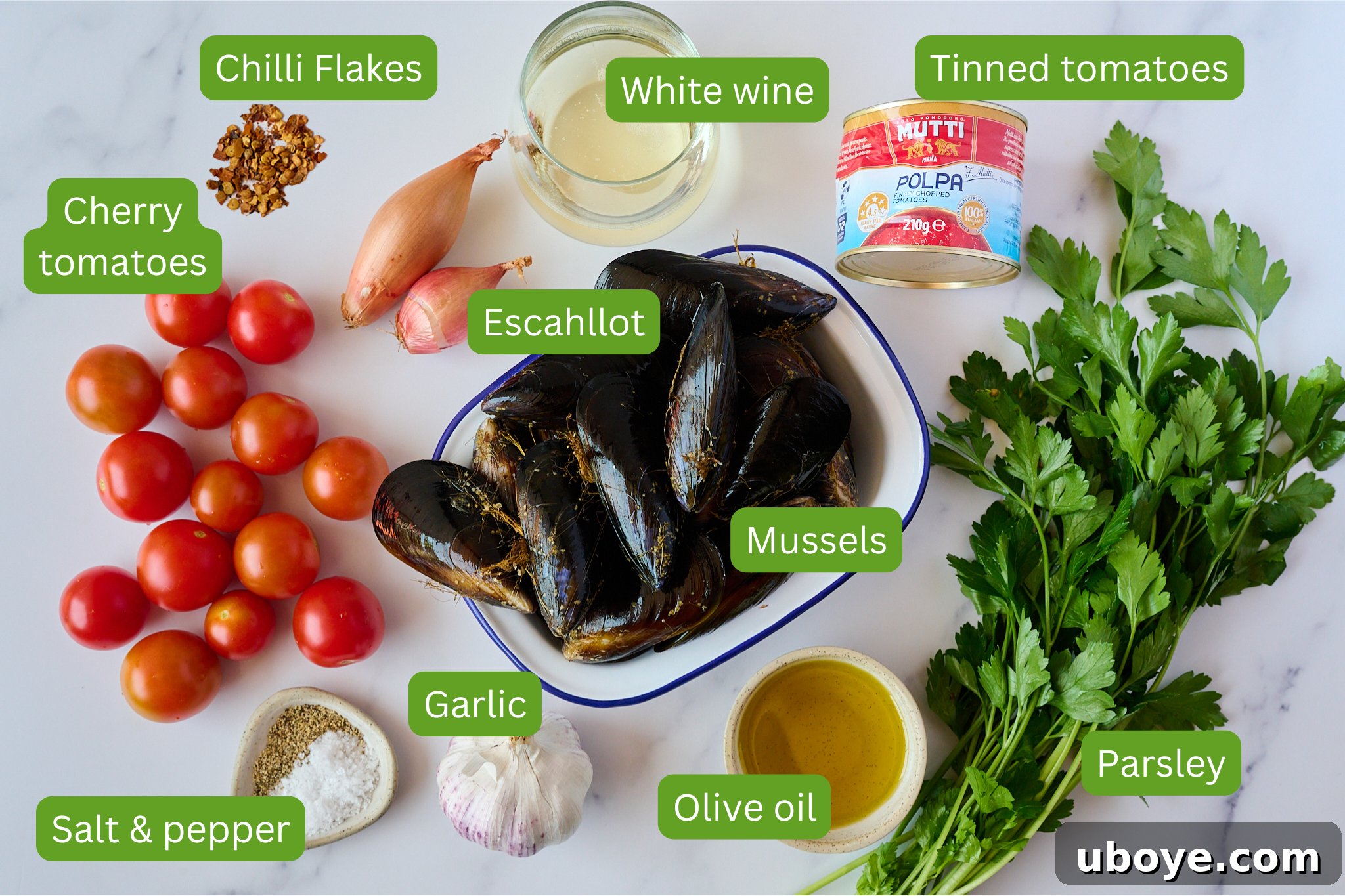 Assortment of fresh ingredients laid out for mussels with chili and tomato.