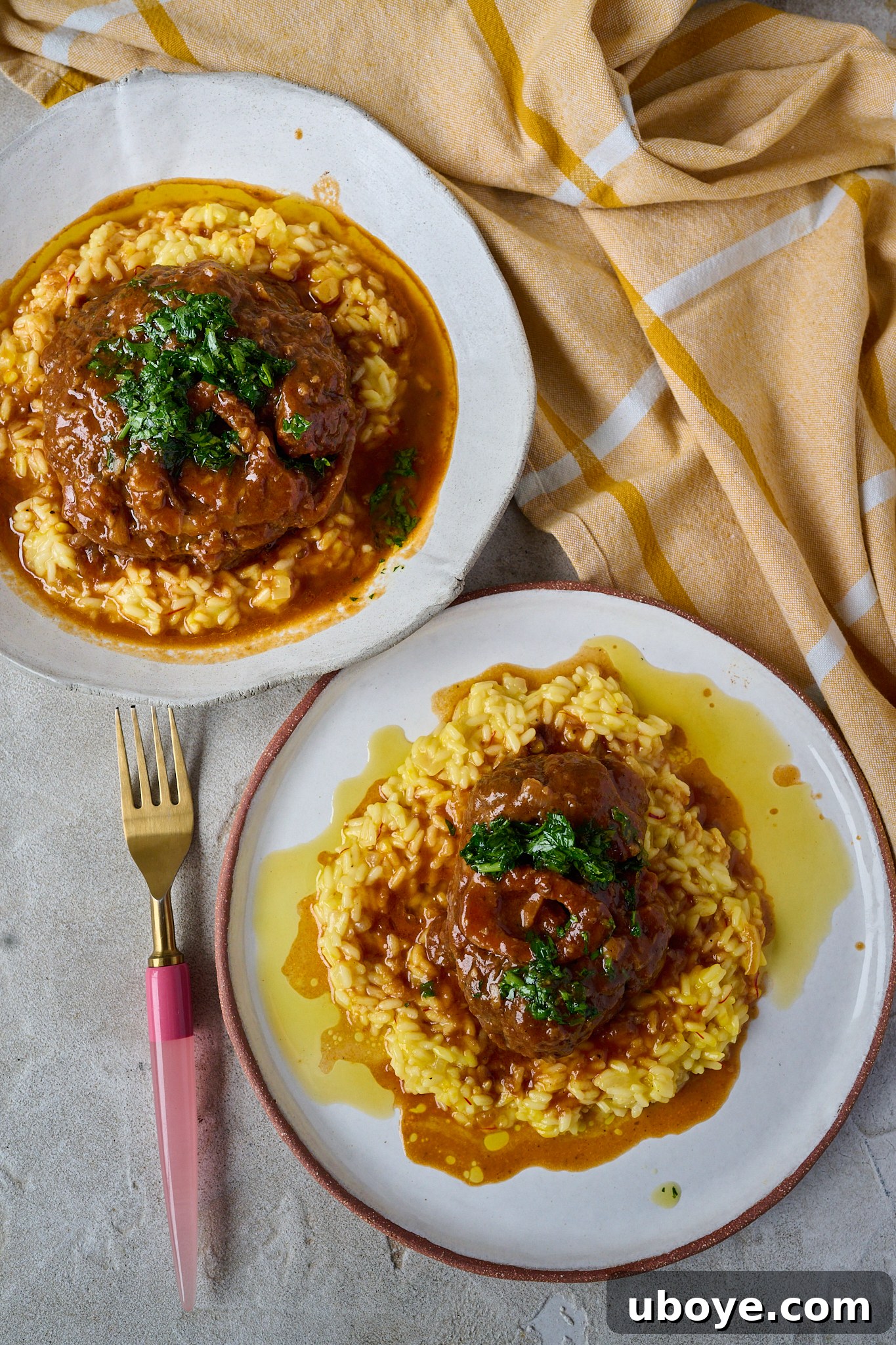 Braised Osso Buco with Zesty Gremolata and Creamy Risotto 13 Two plates of Osso Buco with saffron risotto and gremolata, showcasing the delicious meal.