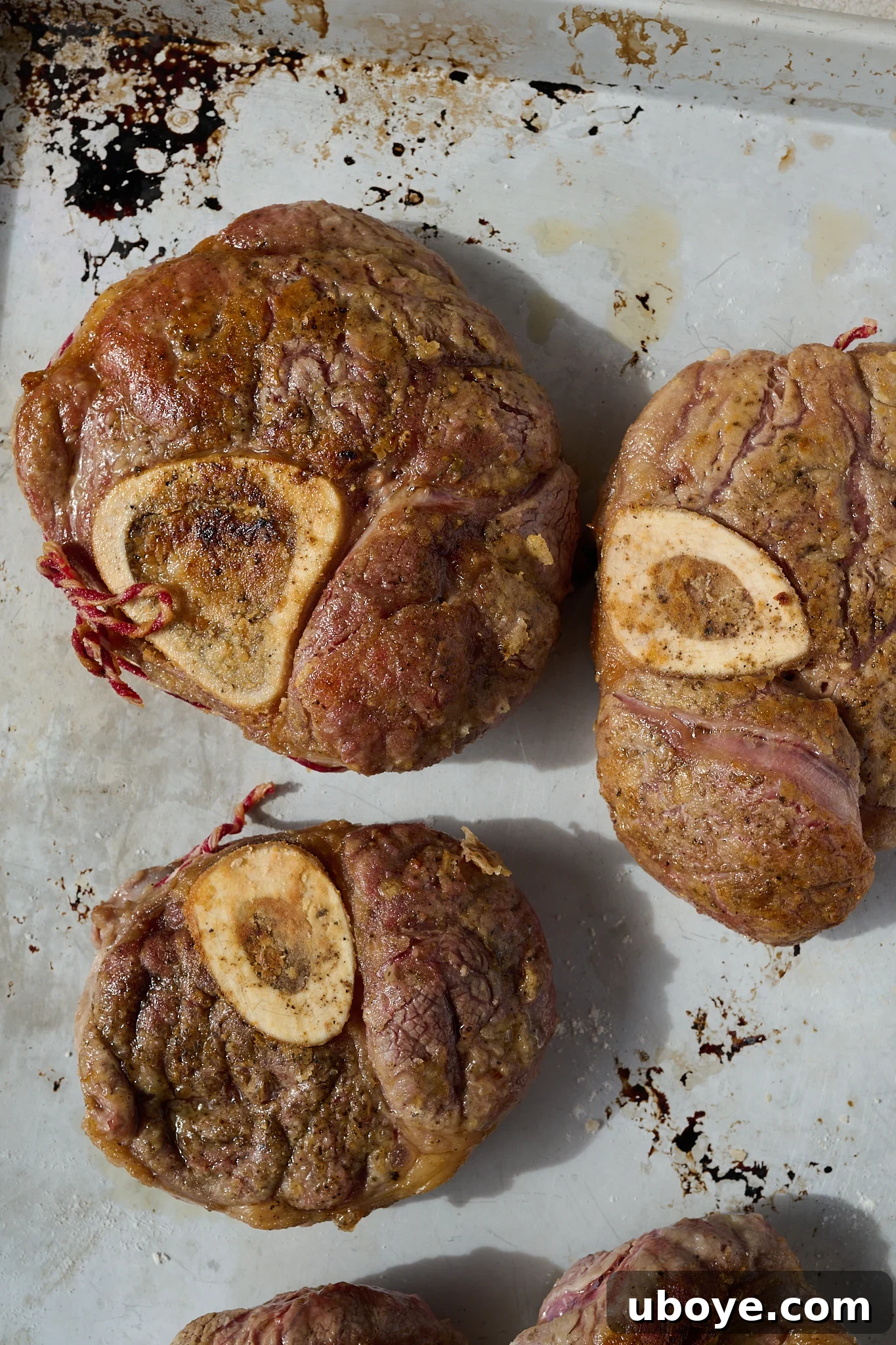 Braised Osso Buco with Zesty Gremolata and Creamy Risotto 6 Golden-brown seared veal shanks in a heavy-based pot.
