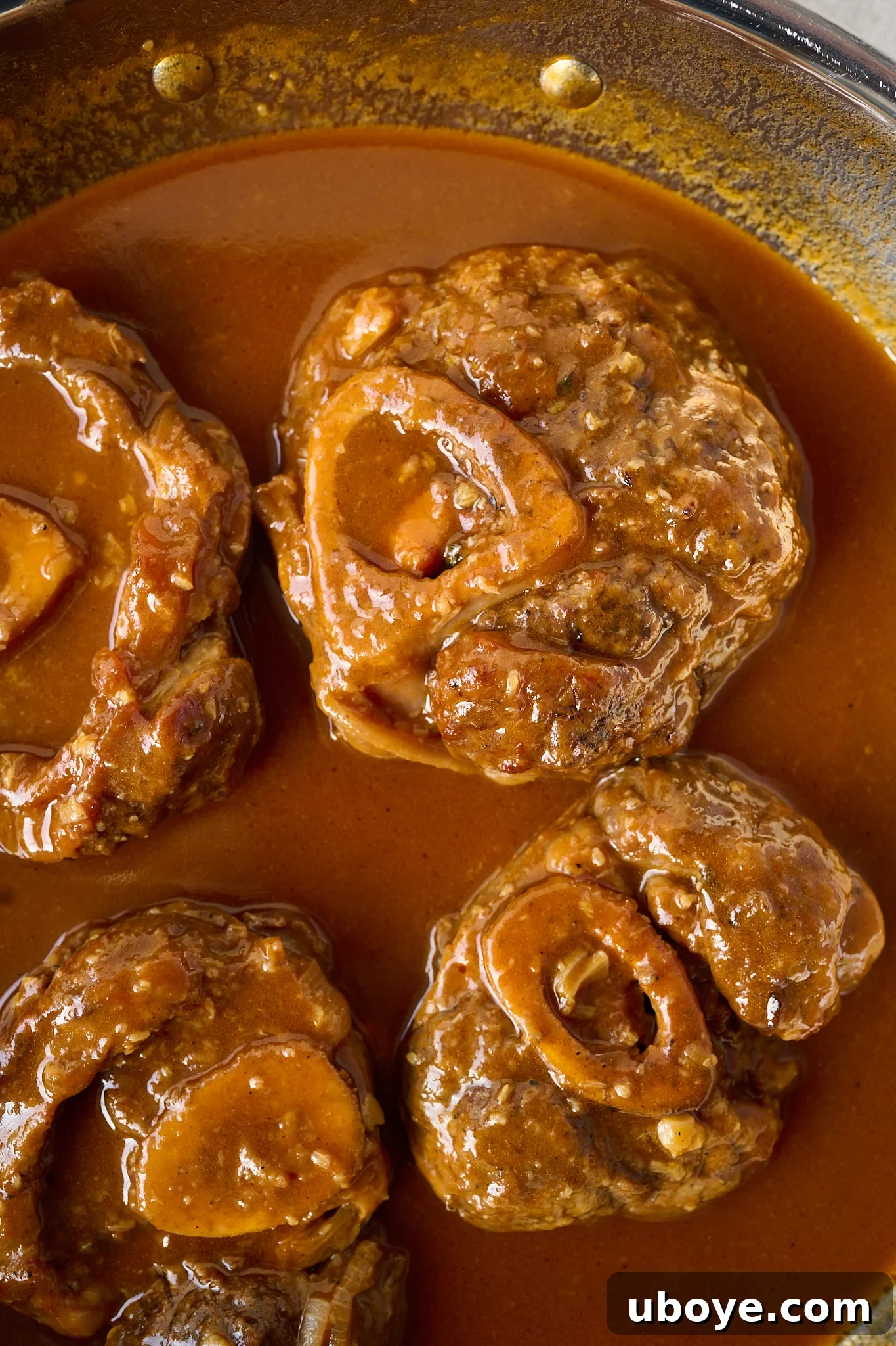 Braised Osso Buco with Zesty Gremolata and Creamy Risotto 9 Tender veal shanks being basted in a refined, silky sauce.