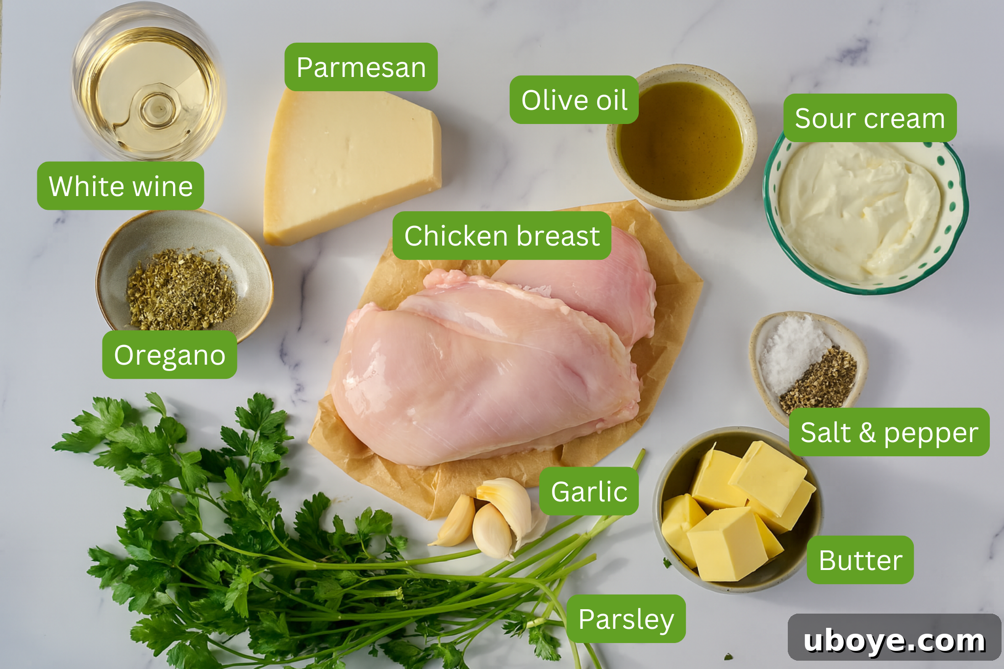 Ingredients for creamy parmesan chicken are shown including white wine, parmesan, olive oil, sour cream, salt and pepper, butter, parsley, garlic, oregano.