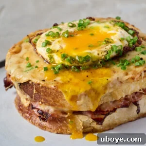 A beautifully presented Croque Madame, sliced to reveal its luscious layers.