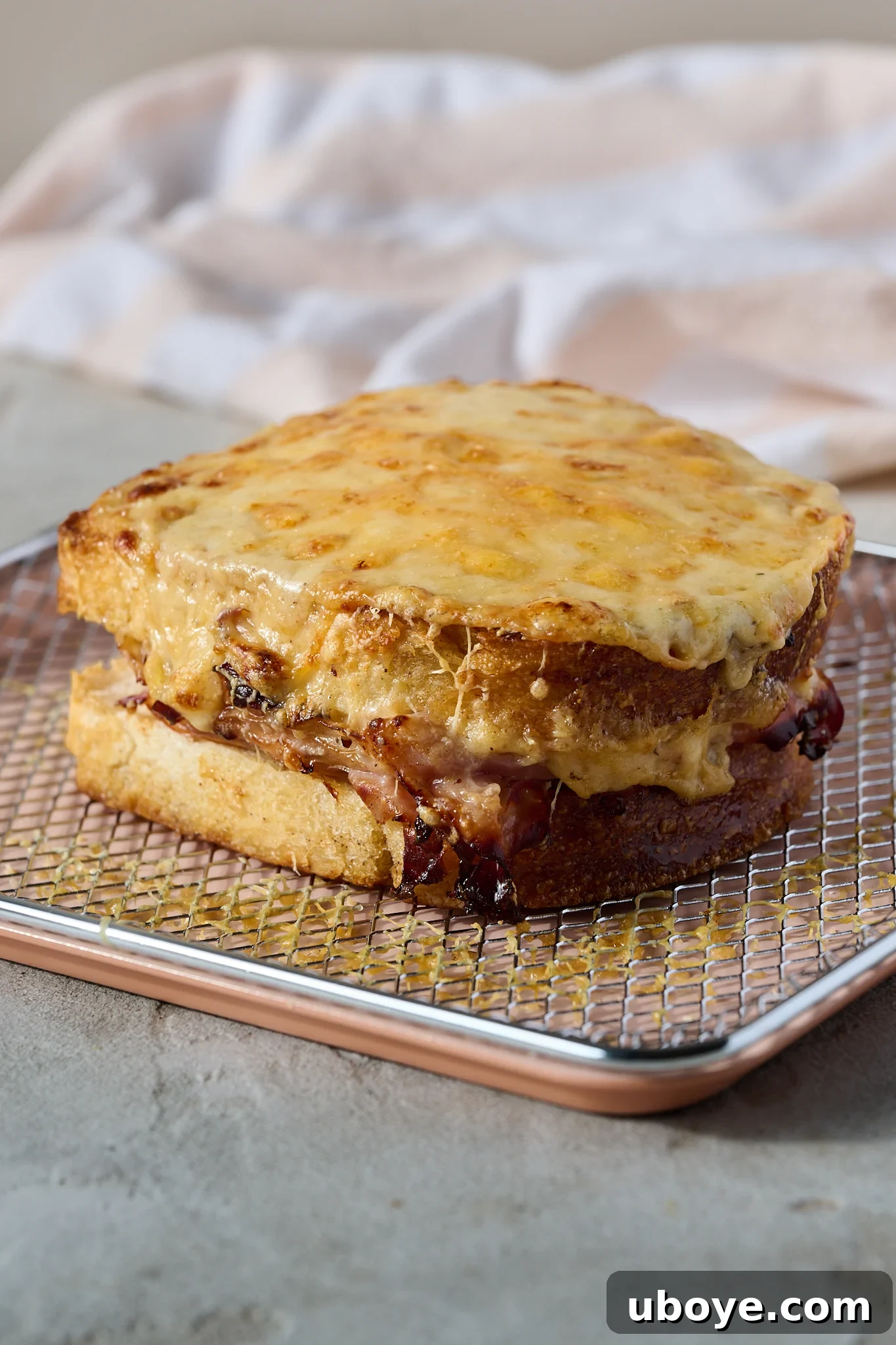 The Crowned Croque 8 Croque Madame grilling under the broiler until the cheese is melted and bubbly.