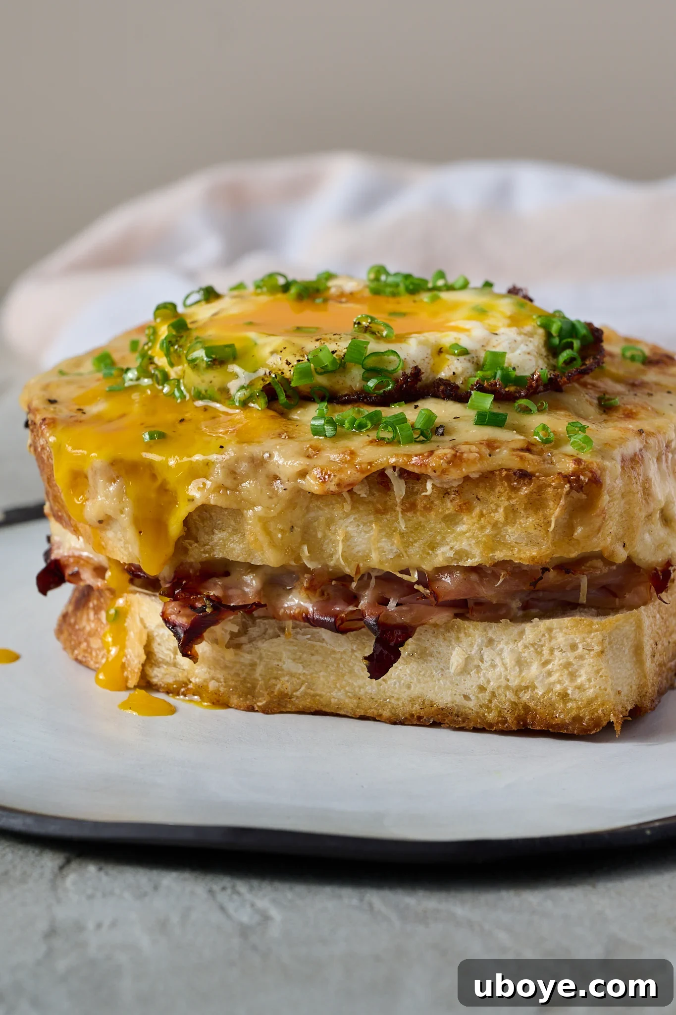 The Crowned Croque 9 Finished Croque Madame with a fried egg and fresh chives.