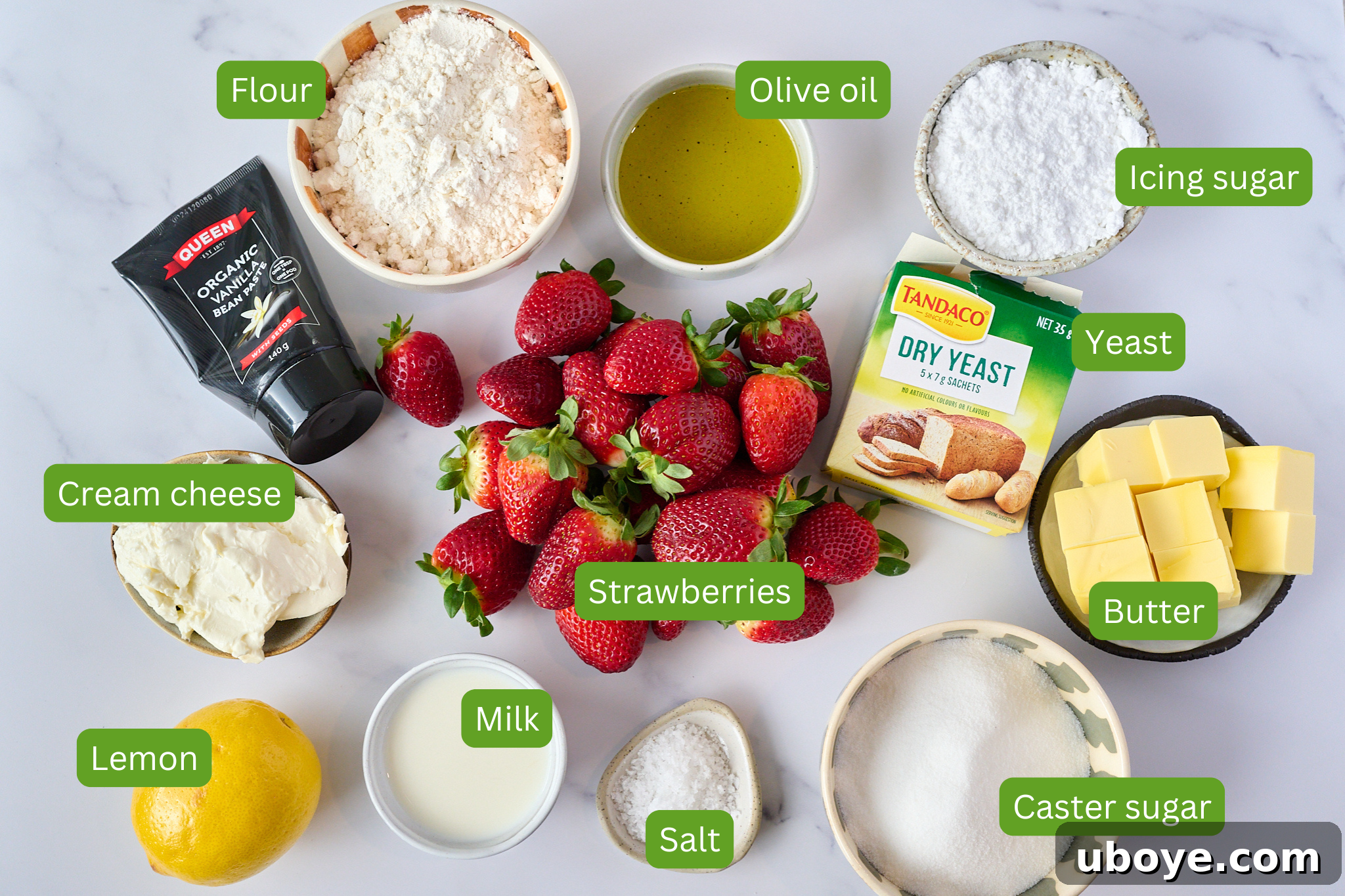 Sweet Focaccia with Strawberry Jam and Cream Cheese Glaze 3 Ingredients for strawberry jam focaccia are laid out onto marble backdrop. Ingredients include flour, olive oil, icing sugar, yeast, butter, caster sugar, salt, milk, lemon, cream cheese, vanilla extract, strawberries.