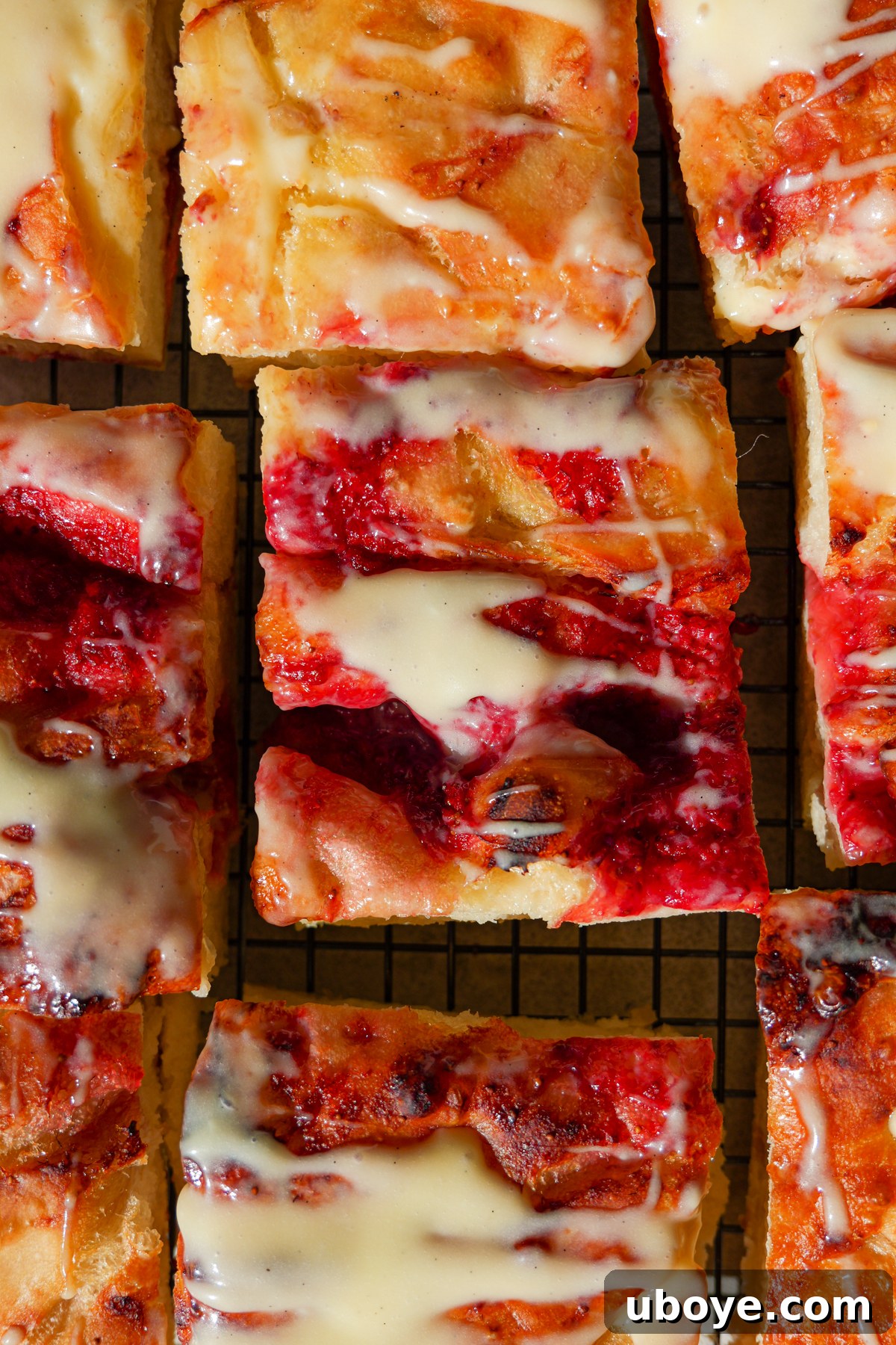 Sweet Focaccia with Strawberry Jam and Cream Cheese Glaze 9 Focaccia is sliced and has been drizzled with cream cheese glaze.