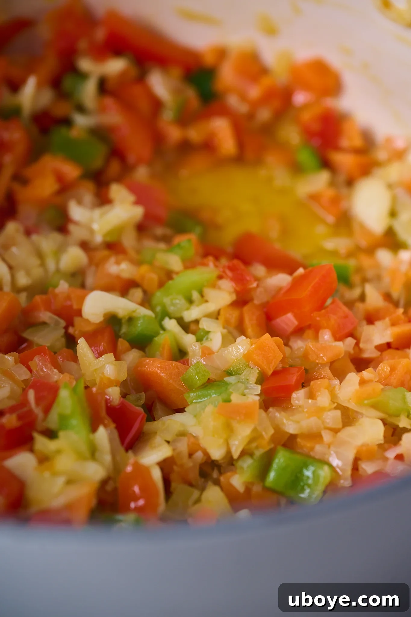 Authentic Vegan Lentejas: A Spanish Comfort Stew 6 The diced sofrito ingredients (onions, capsicums, carrots) are gently sautéed in a large white pot with a generous amount of olive oil, developing their fragrance and softness.
