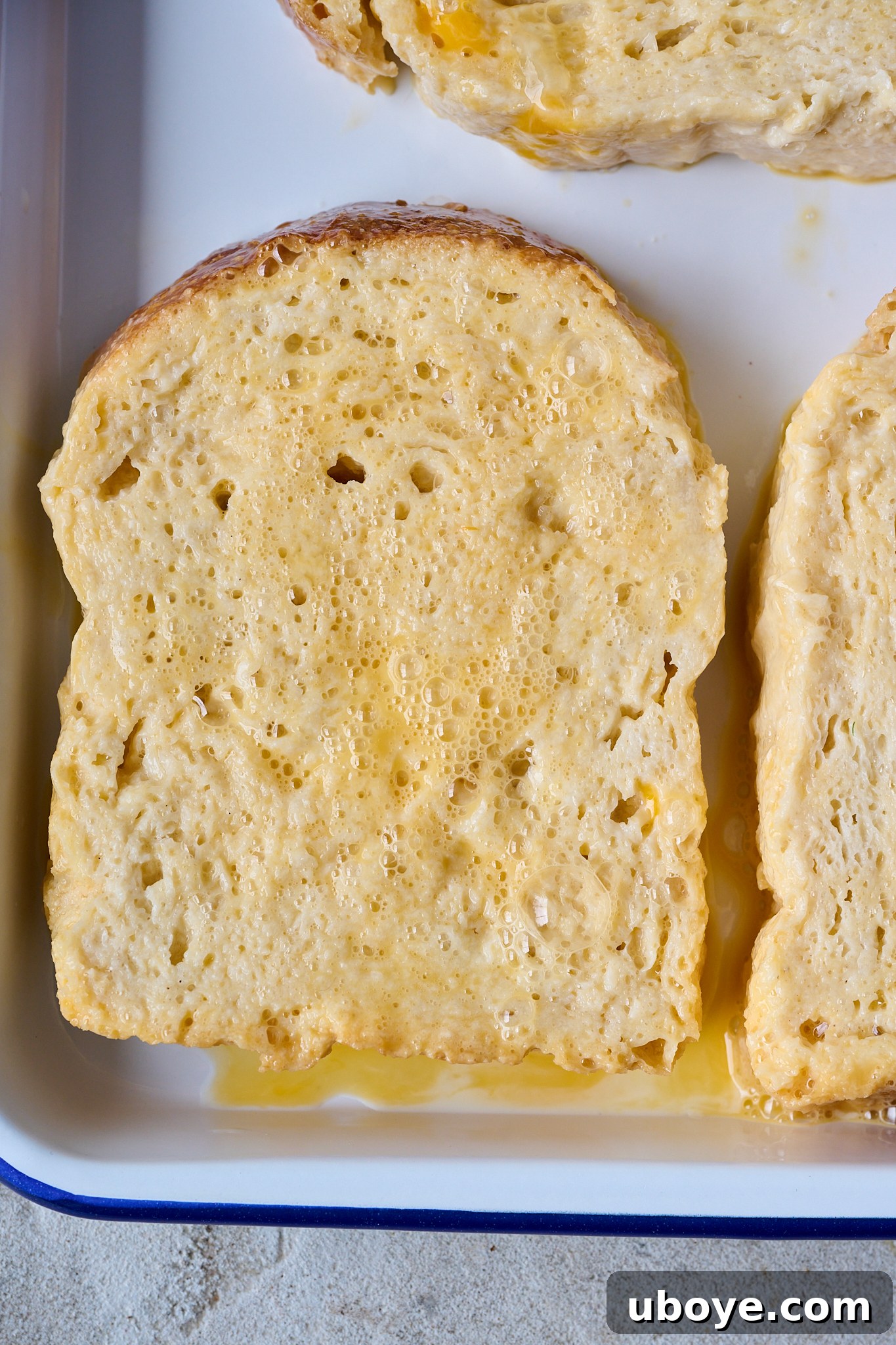Torrijas Spain's Beloved French Toast 6 Thick slices of day-old white bread are submerged in beaten eggs, ensuring each piece is fully coated and ready for frying.