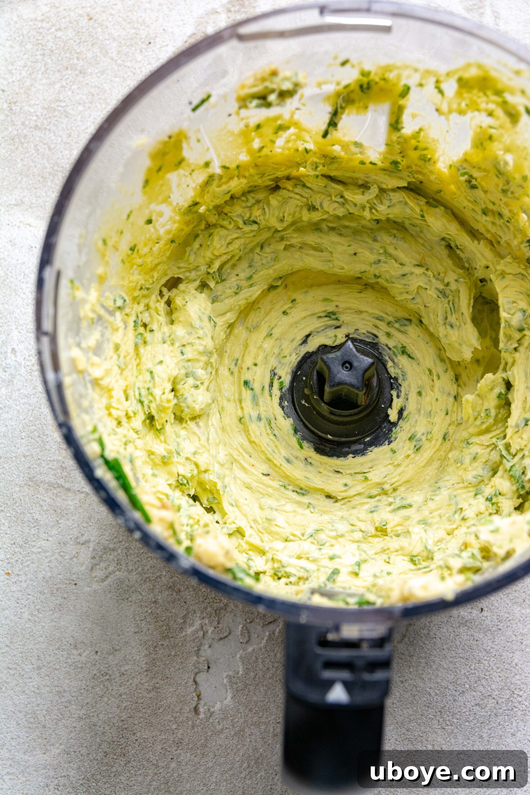 The Ultimate Homemade Garlic Butter 7 The garlic butter has been thoroughly blended to a smooth, creamy consistency, showcasing its rich texture and color.