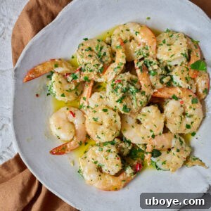 Succulent garlic butter shrimp (prawns) served in a pan.