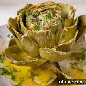 Garlic butter artichoke with cheese and herbs, ready for serving.