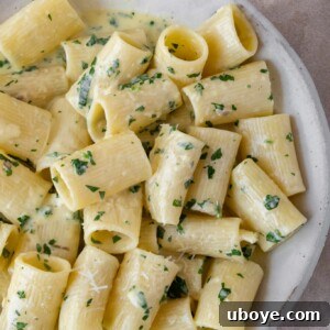 Creamy garlic butter pasta, garnished with fresh parsley.