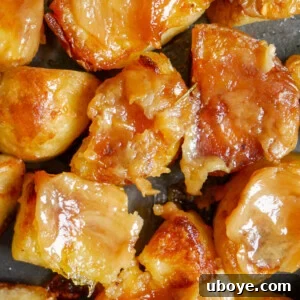 Garlic Confit Crispy Roasted Potatoes, golden, crispy, doused in olive oil, and finished with cheese and rosemary