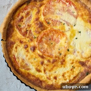 Heirloom Tomato and Cheddar Cheese Tart with a rich egg and cream filling, topped with fresh tomatoes
