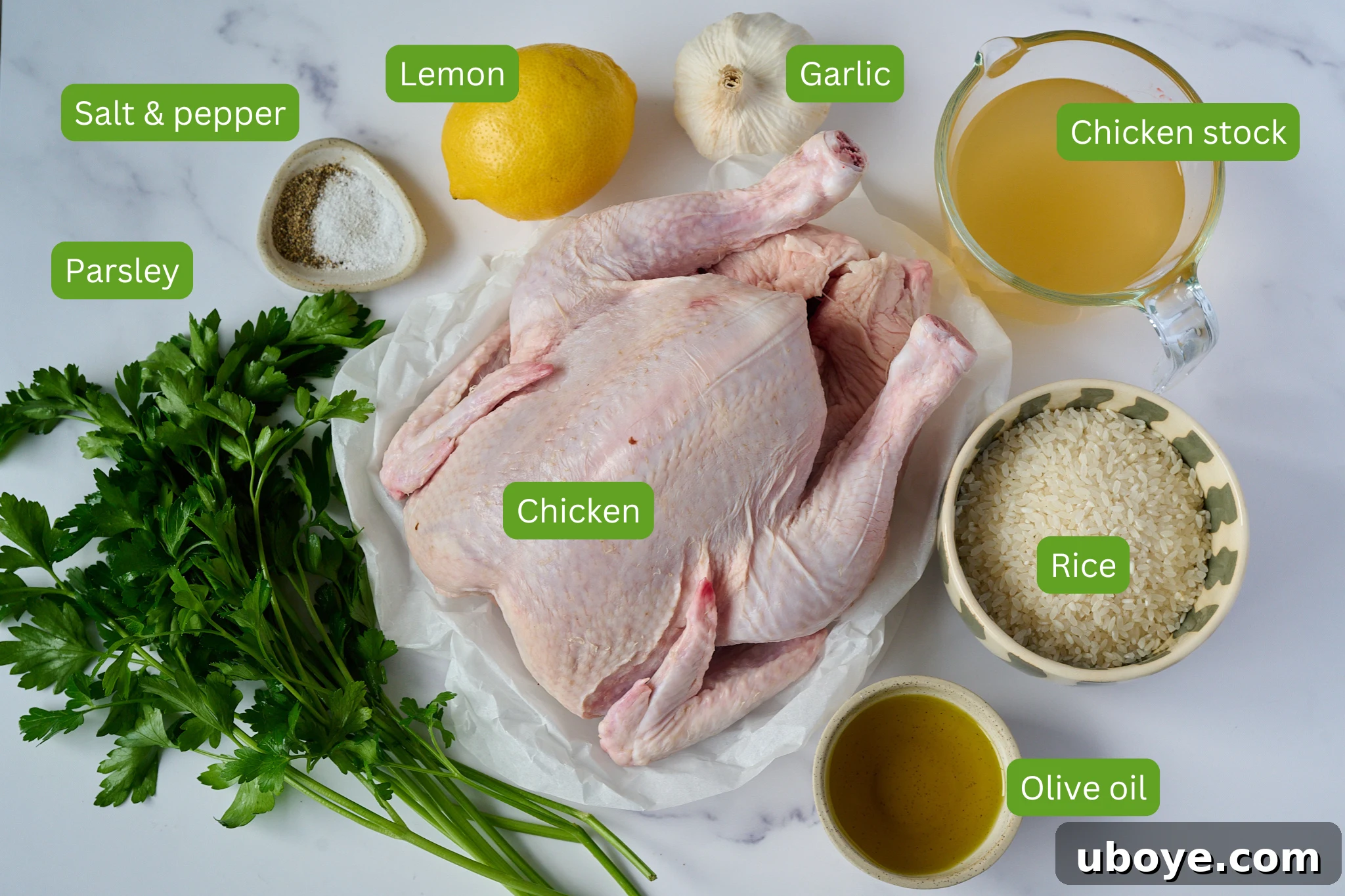 Golden Chicken & Fragrant Garlic Rice Skillet 4 Ingredients for one pan chicken and rice are shown. You can see chicken stock, rice, olive oil, chicken, garlic, lemon, salt and pepper and parsley.