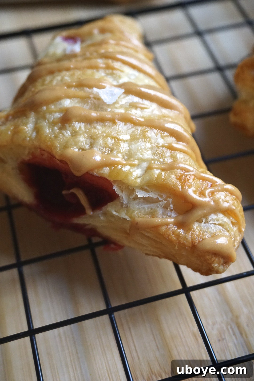 Simple Flaky PBJ Hand Pies 3 Close-up of a vegan peanut butter and jelly turnover showing the filling