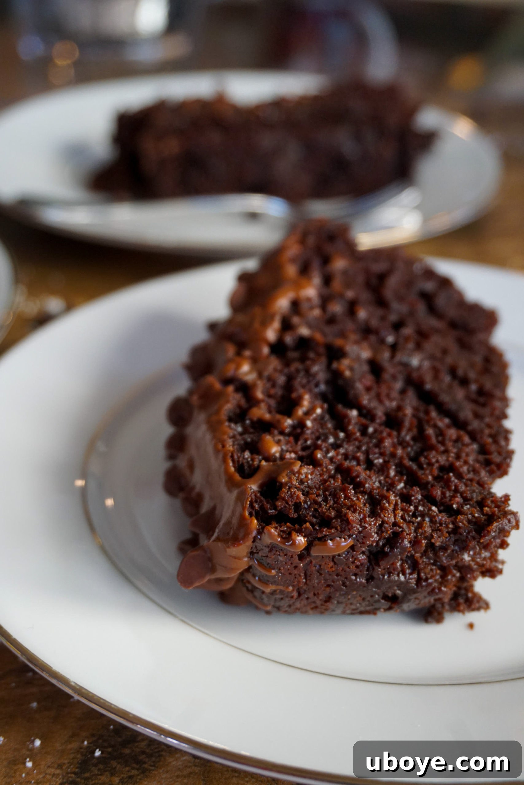Guilt-Free Chocolate Bliss Cake 5 Close-up of a slice of vegan chocolate cake with frosting and toppings