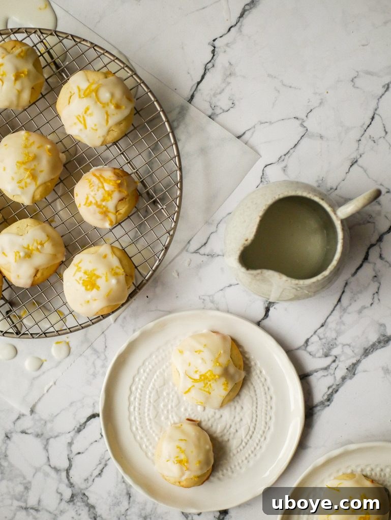 A stack of lemon olive oil cookies with a generous lemon drizzle
