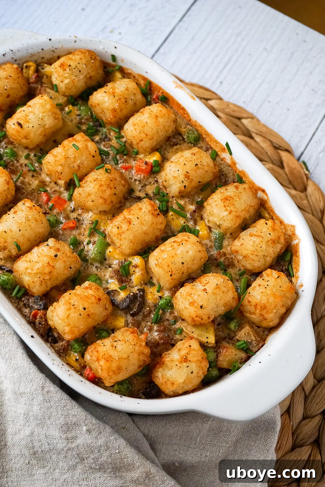 Close-up view of the rich, creamy, and chunky filling of the vegan tater tot casserole before baking.