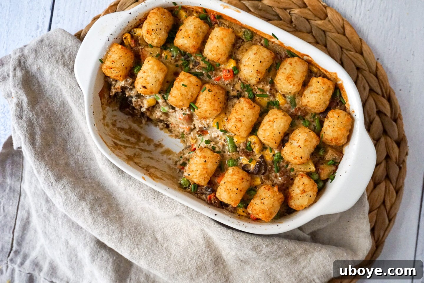 All the fresh and frozen ingredients for the vegan tater tot casserole, neatly laid out on a kitchen counter.