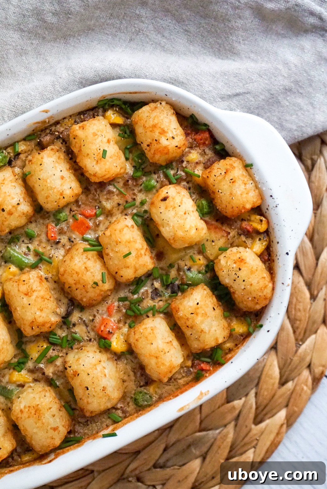 A large baking dish filled with the fully cooked vegan tater tot casserole, ready to be served family-style.
