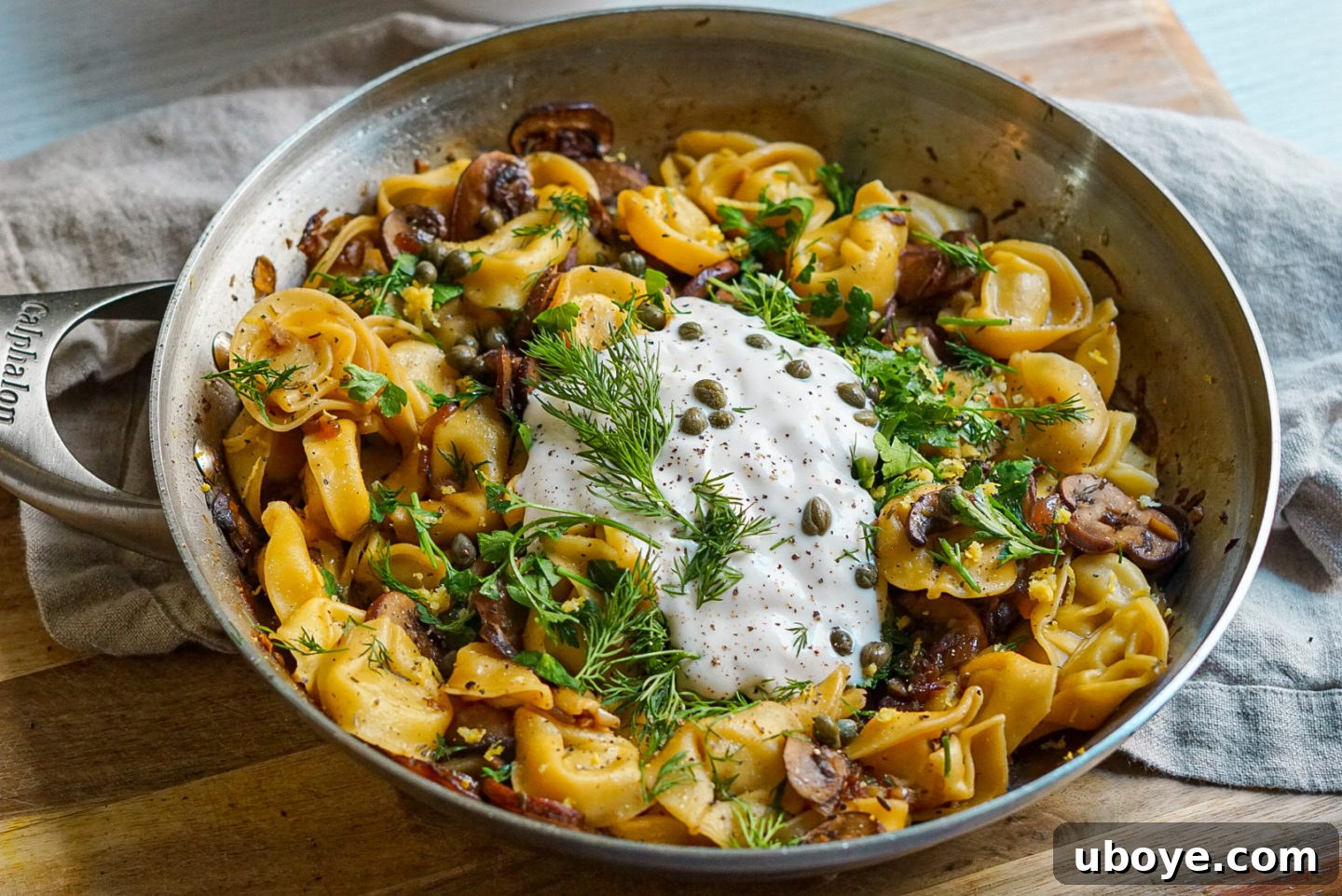 Delicious creamy vegan garlic mushroom tortellini with lemon and dill served in a bowl, ready to eat.