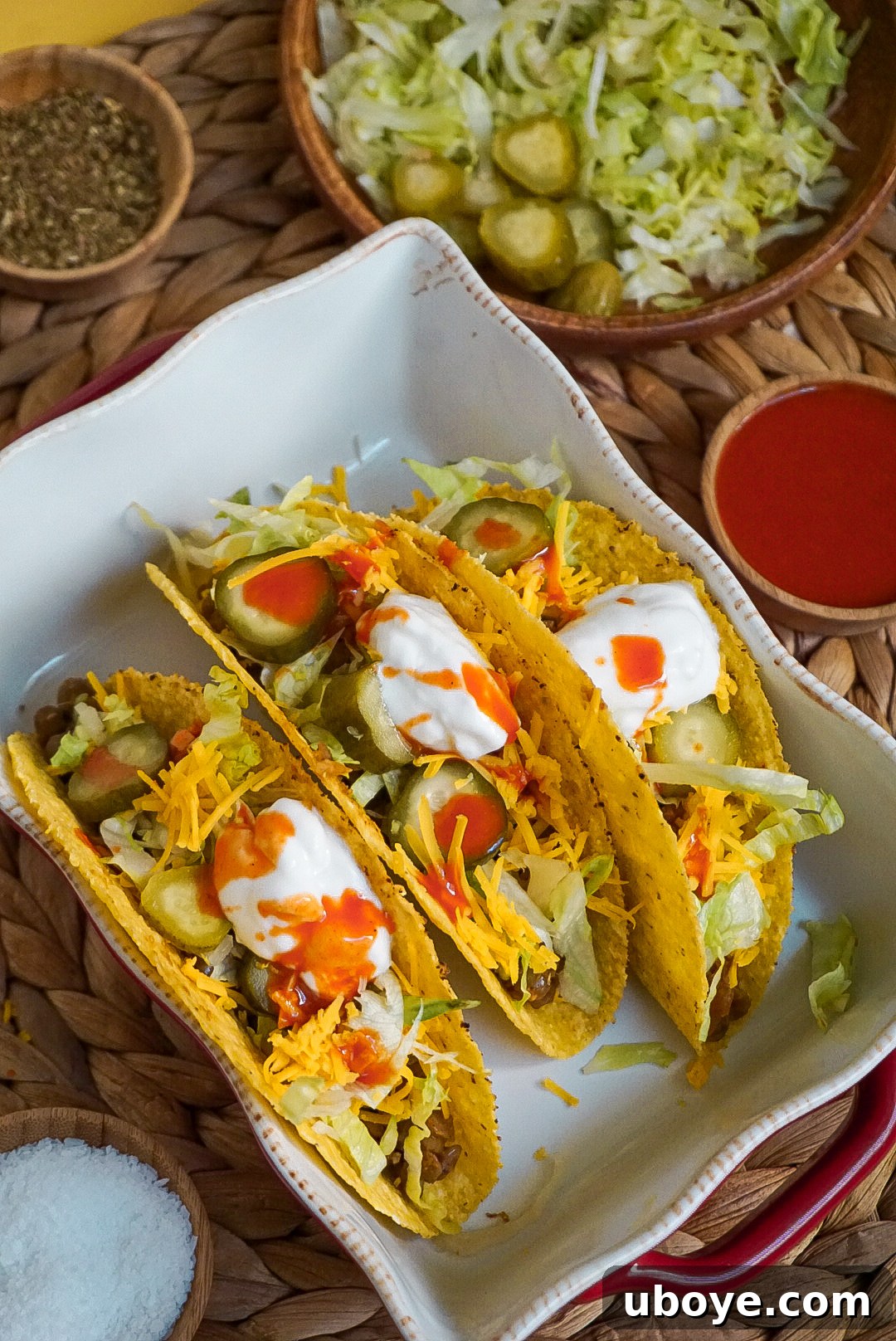 Dill Pickle Plant-Based Beef Tacos 3 Close-up of a fully loaded vegan beef and pickle taco with melted cheese and fresh toppings