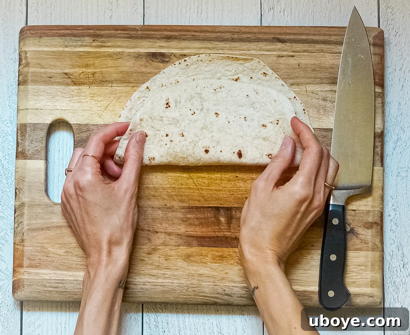 Plant-Powered Toaster Quesadillas 8 Image showing the first fold of the tortilla, gently bent in half.