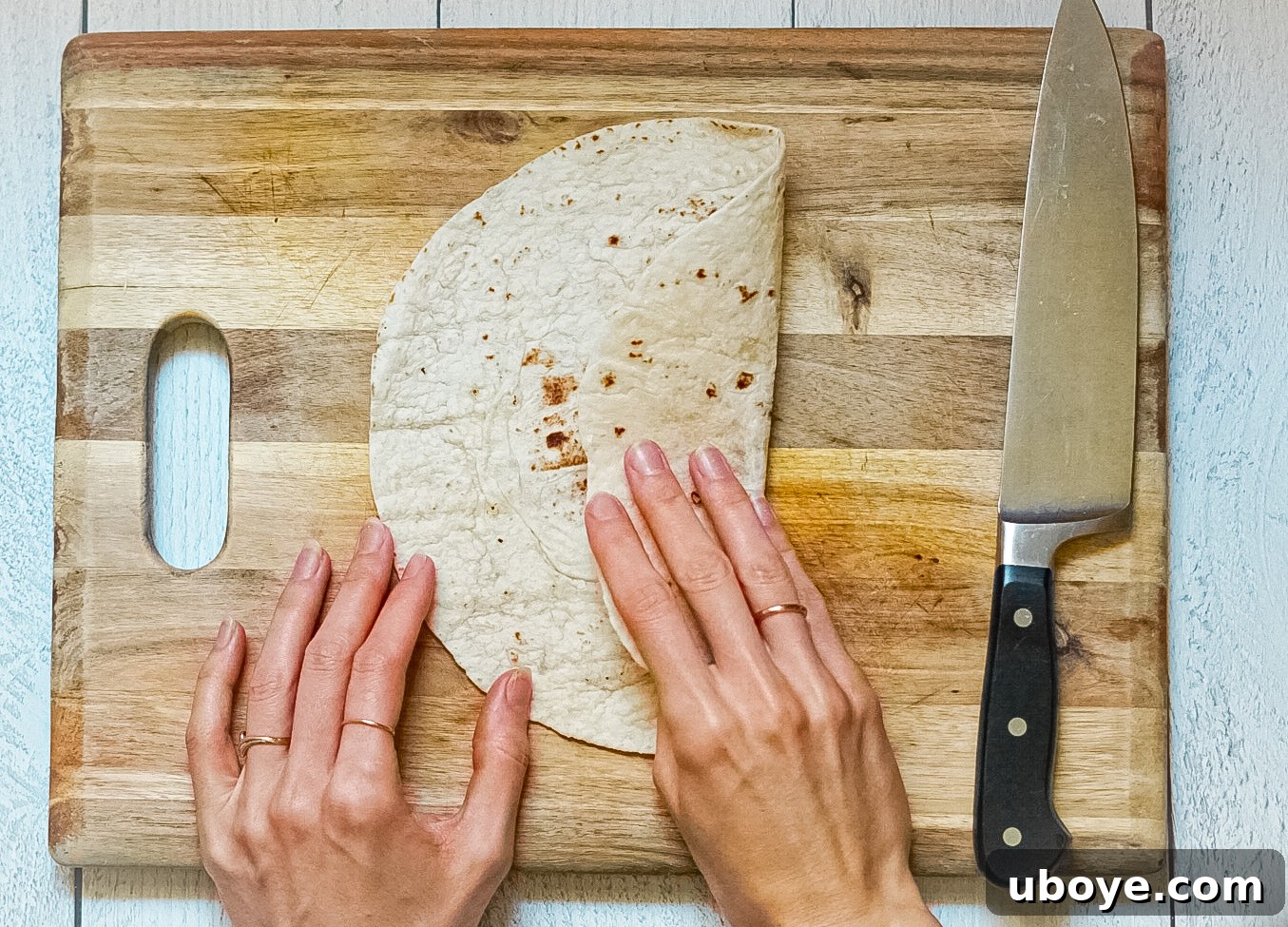 Plant-Powered Toaster Quesadillas 9 Image illustrating the second fold of the tortilla, with the right third folded inwards.